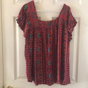 Red and blue patterned blouse with cap sleeves